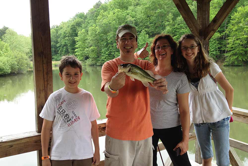 family holding a fish that they just caught